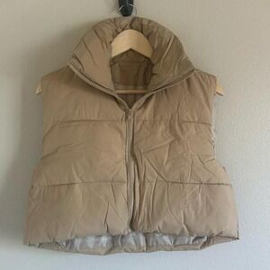 Tan puffer vest with zipper closure and pockets. Size: M